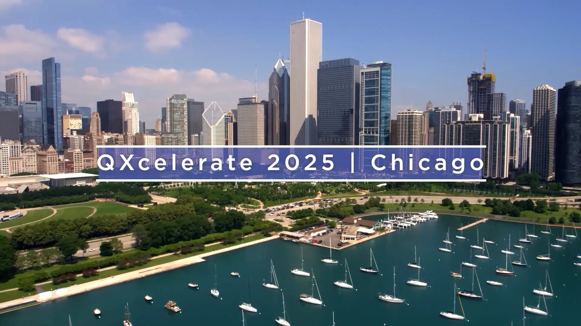 Chicago skyline with a purple banner reading 'Qxcelerate 2025 | Chicago' across the midsection, marina in the foreground.